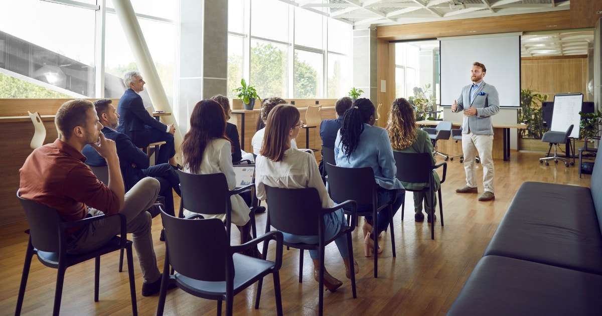 A businessman announcing a Phoenix office relocation to employees