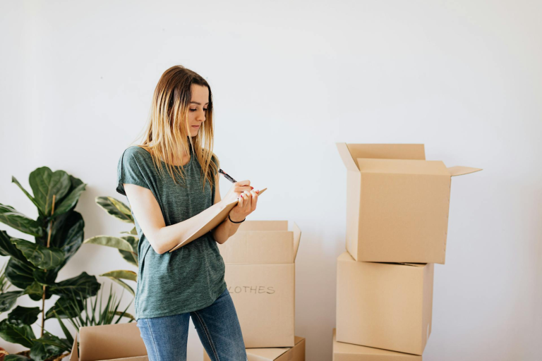 Woman writing notes while packing