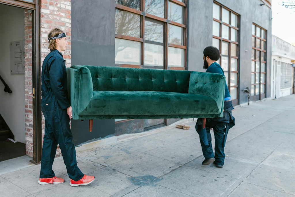 Professional movers with couch outside