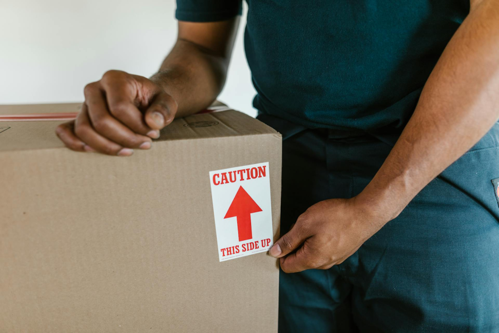 Pro mover packing a moving box