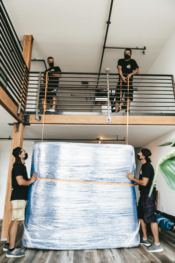 Pro movers with a bed or large box