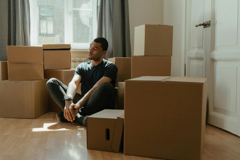 Man sitting with moving boxes