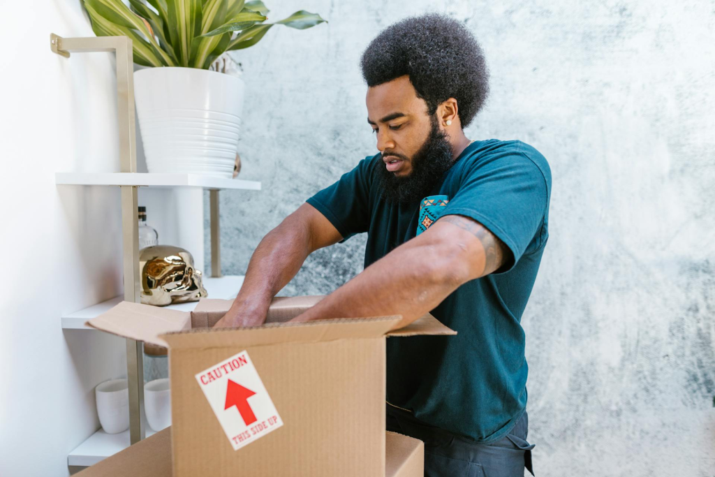 Pro movers filling a moving box